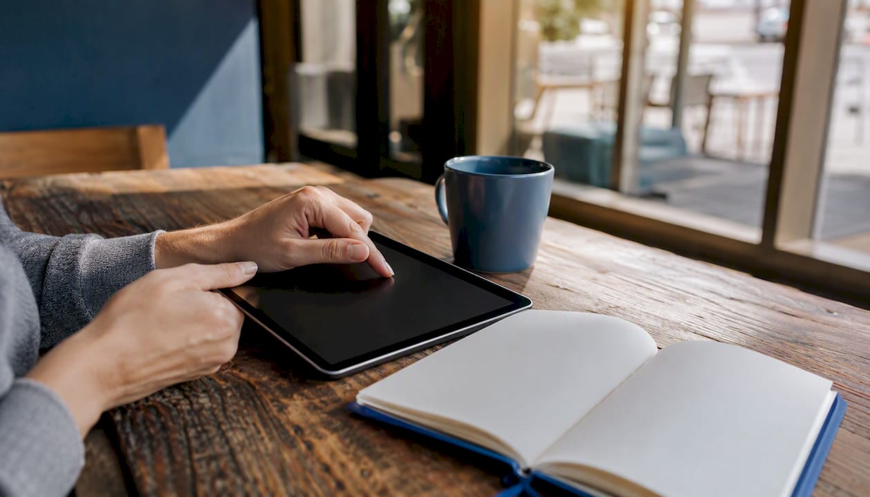 Hands interacting with tablet in hiring tool workflow
