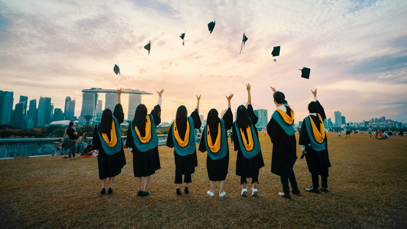 Graduates throwing their caps in the air at a commencement ceremony