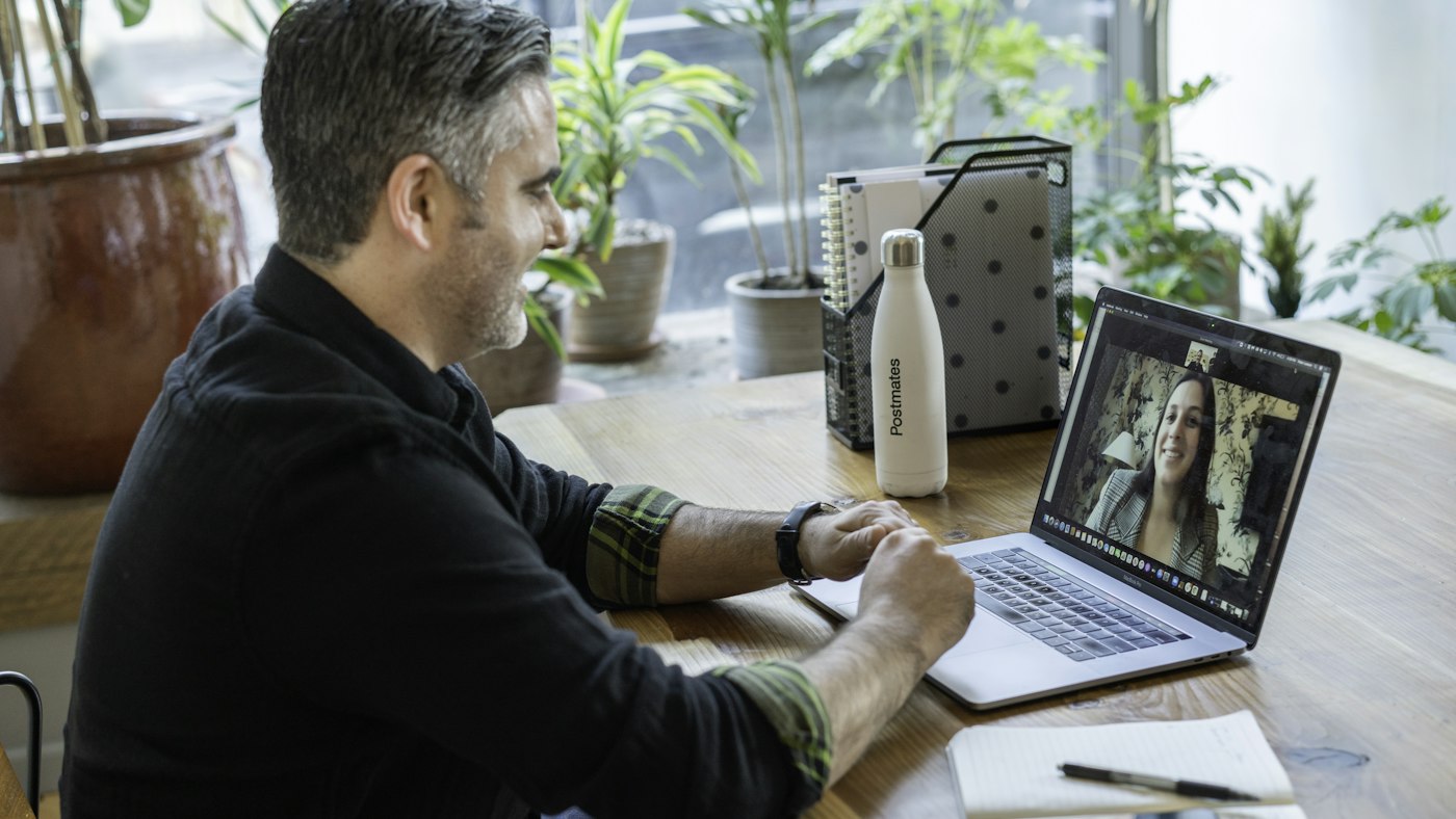 Man on a video call on a laptop during a remote interview